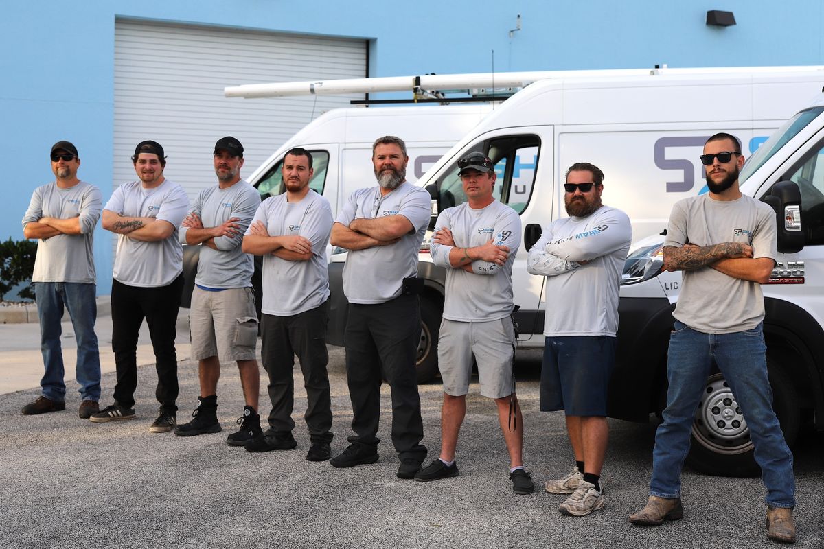 Shaw Plumbing team in front of shop